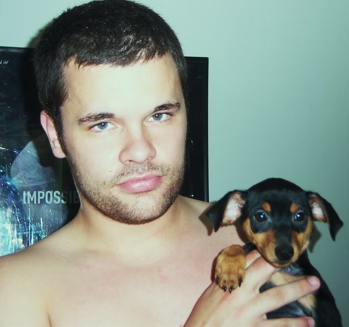 Kyle holding Deuce as a puppy